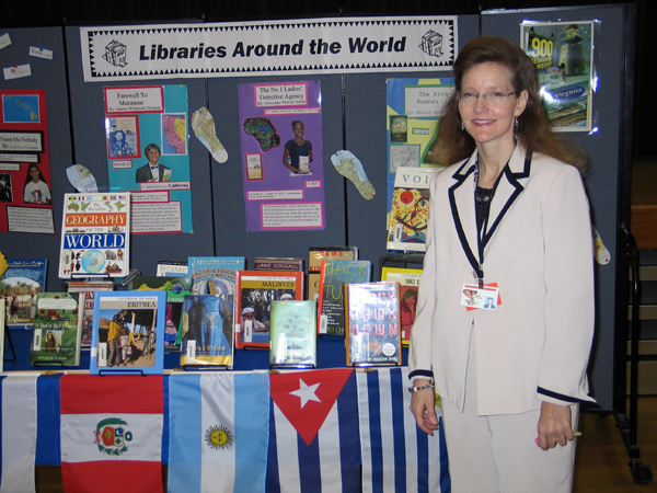Librarian Cindy Stafford alongside the 'Libraries Around the World' display (2006)