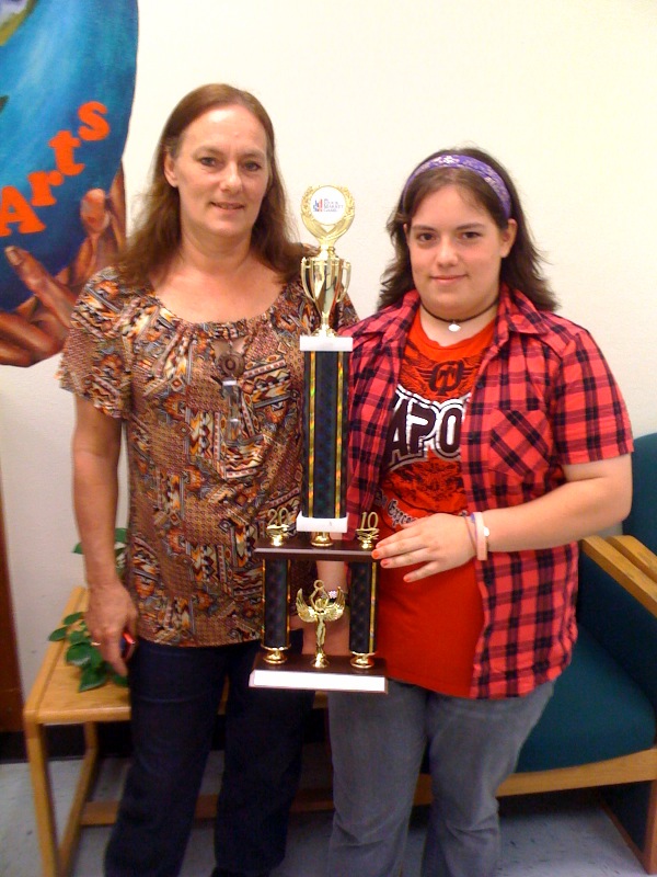 PHOTO CAPTION: Maryann and Ashlee Baez pose with Ashlee's trophy for winning the Florida InvestWrite competition.